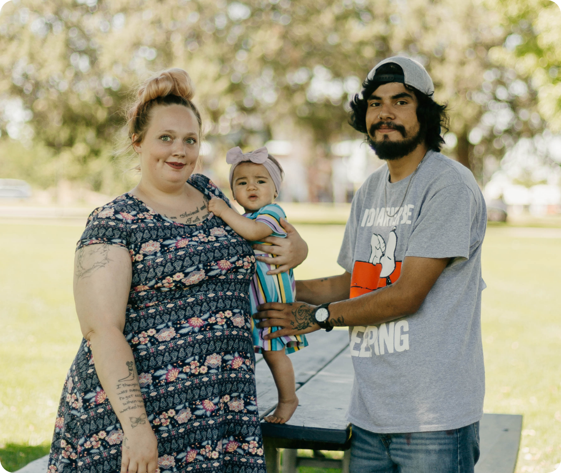 A couple with their baby girl in the park